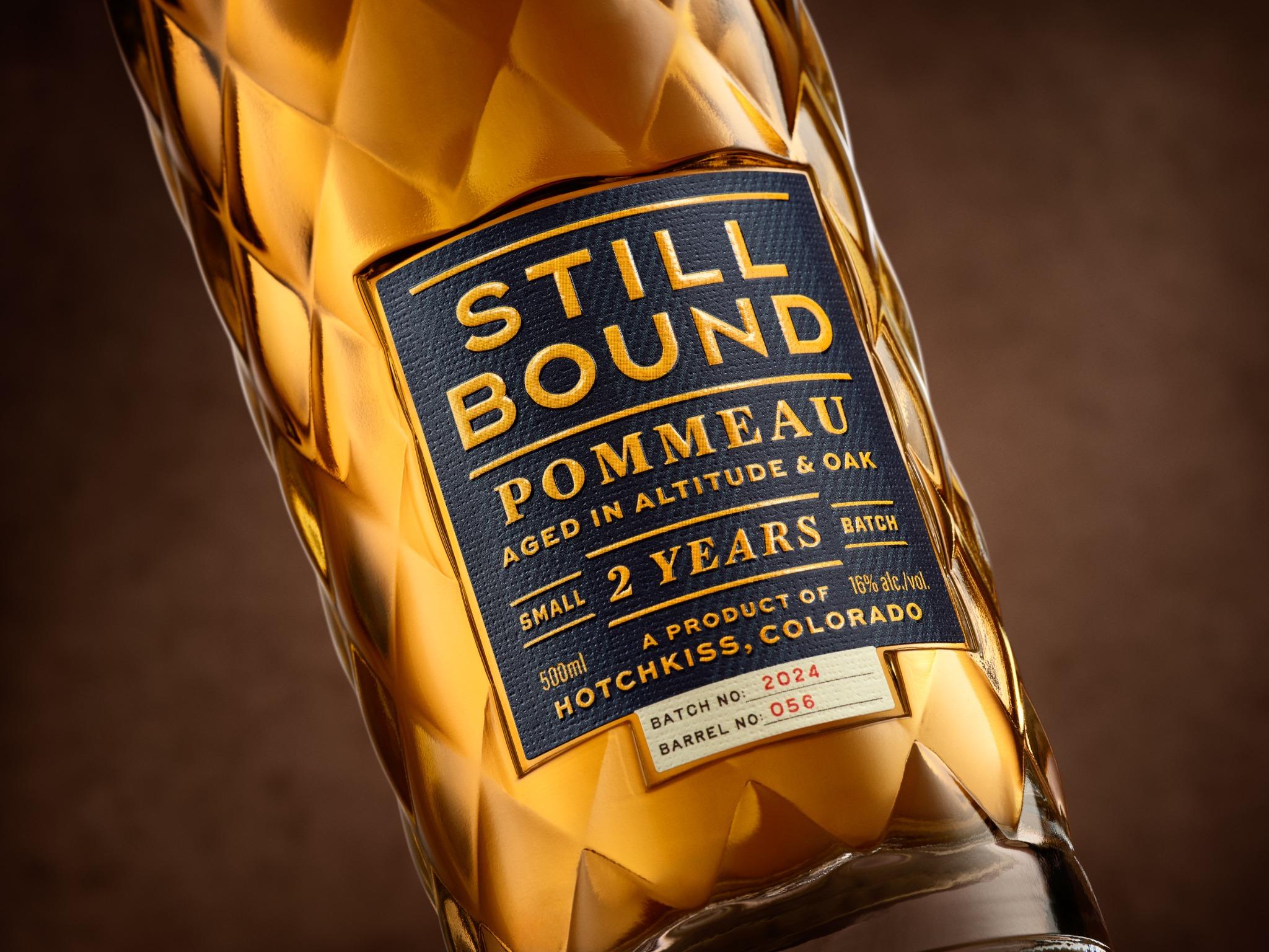Warm light through Stillbound’s diamond glass, with the Pommeau label in detail